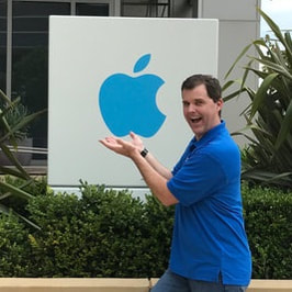 Picture of Mike in front of an Apple office sign in California