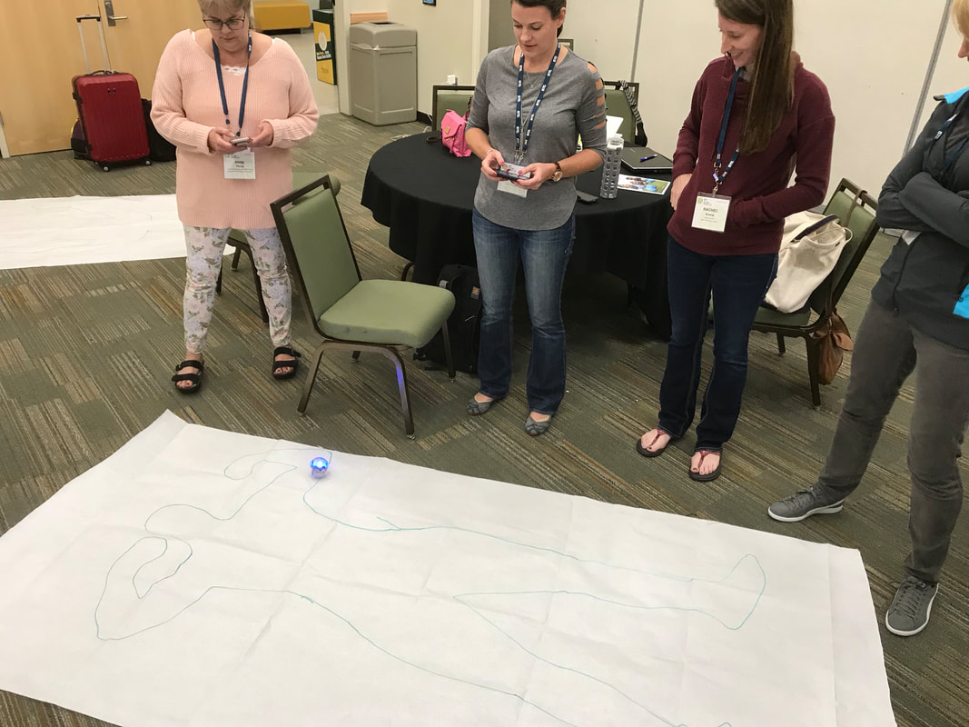 A photo of teachers guiding sphero through a drawing of the human body to demonstrate the circulatory system
